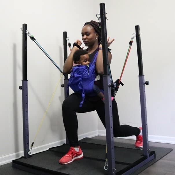 mom working out EvolutionVN home gym with kid son
